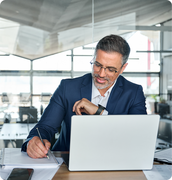 Man working on laptop in modern office.