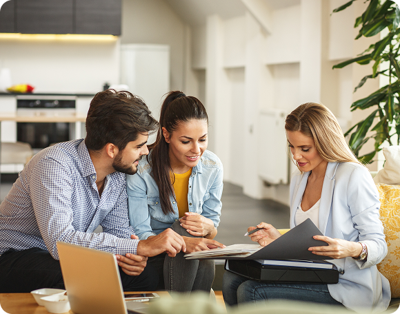 People discussing documents in a modern office.